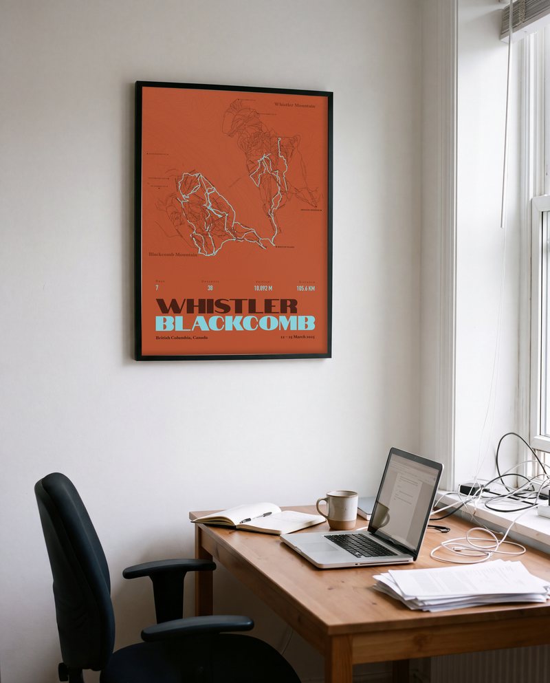 A Whistler Blackcomb ski print in Clay, in a black frame, in a home office